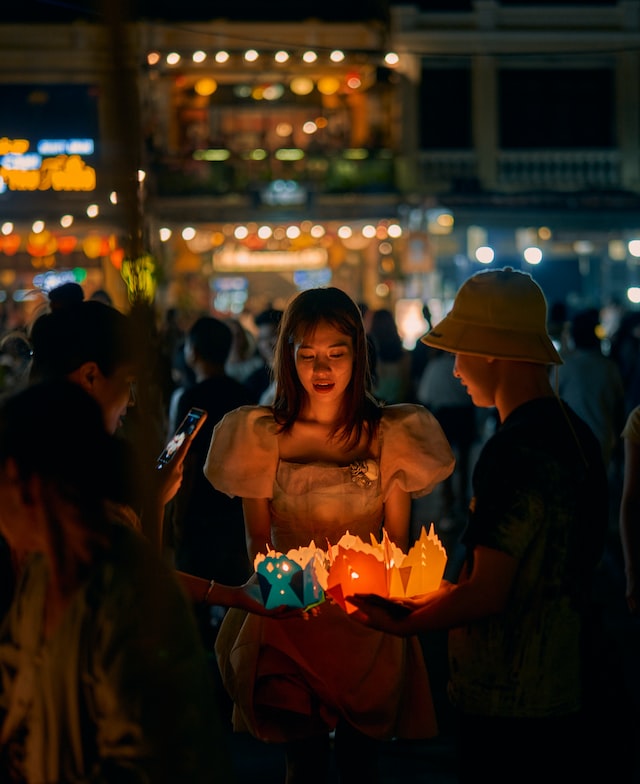 Friends holding candles at night