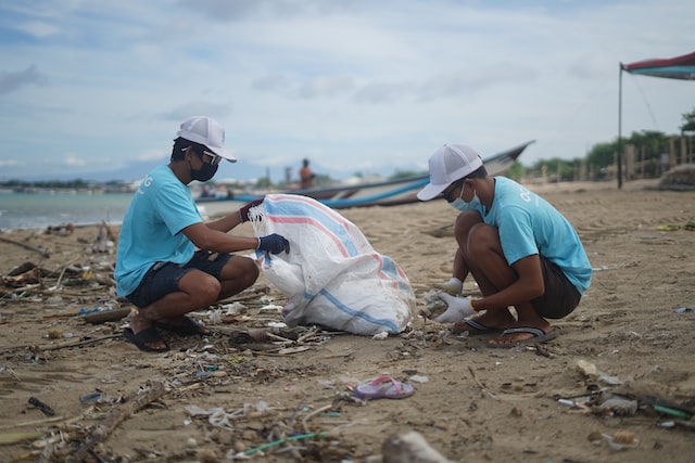 People picking up trash at a beach