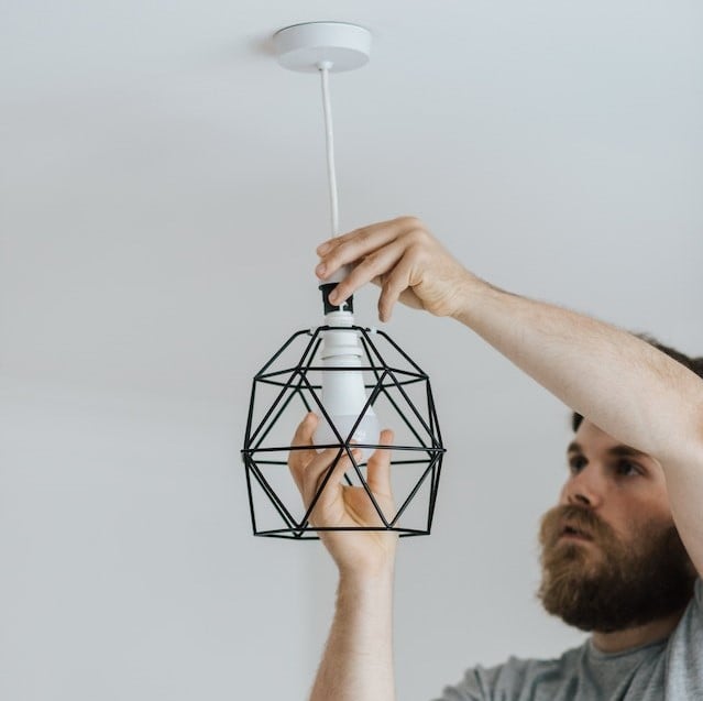 Man installing a light bulb