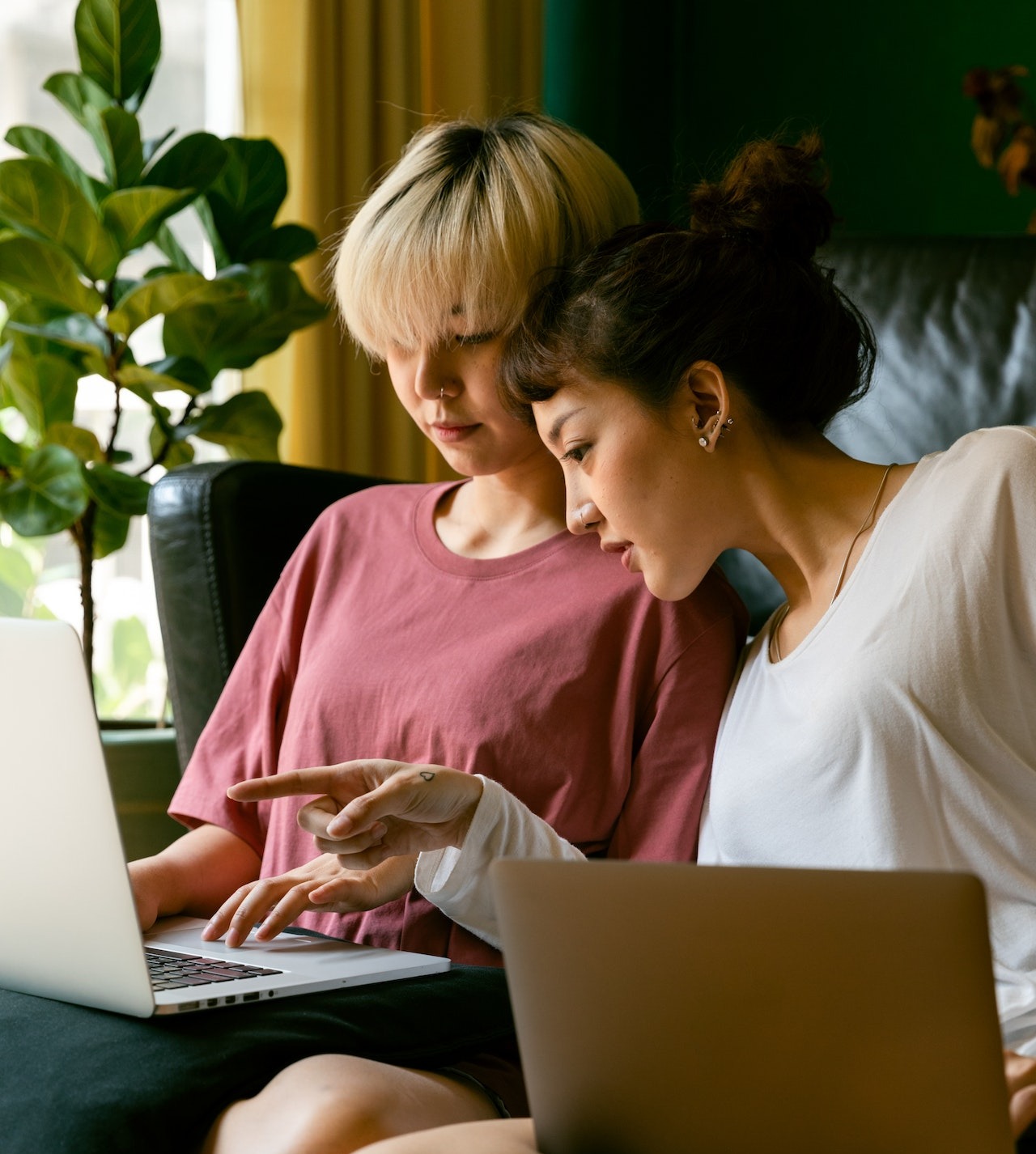Two women reading on their laptops