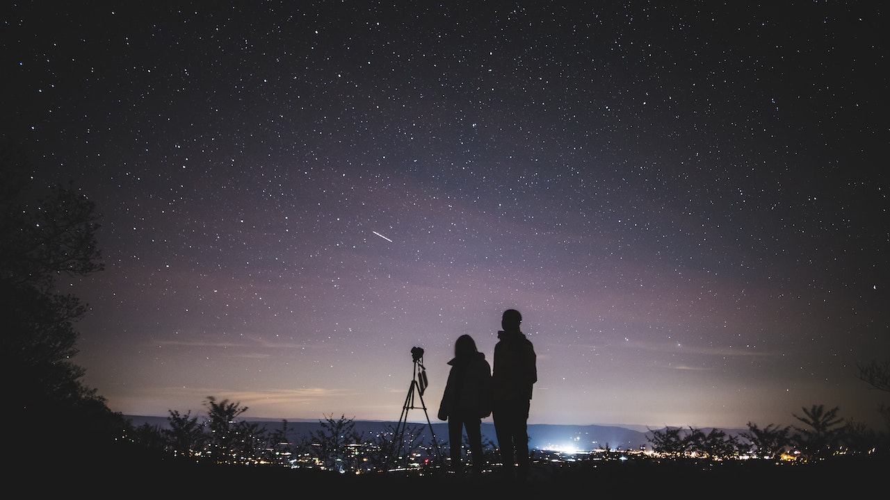 A man and a woman stargazing