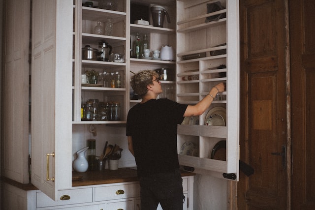 Person looking through their cupboard
