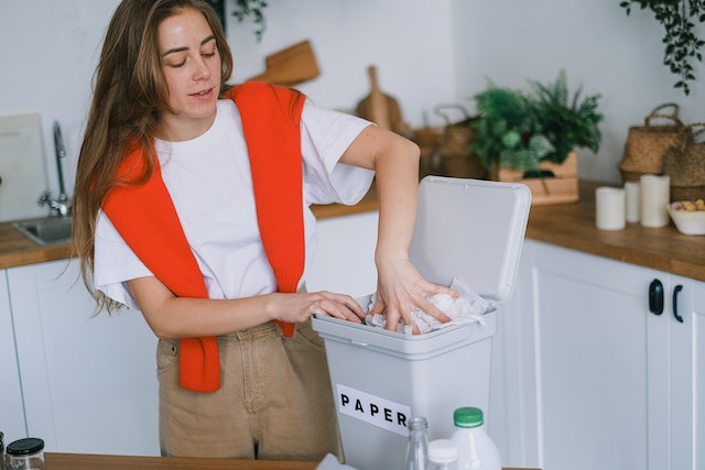 Woman sorting trash at home